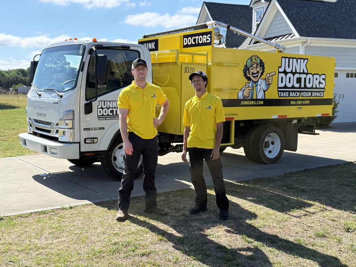 Junk Doctors crew loading a truck at a Raleigh NC home — licensed, insured, background-checked