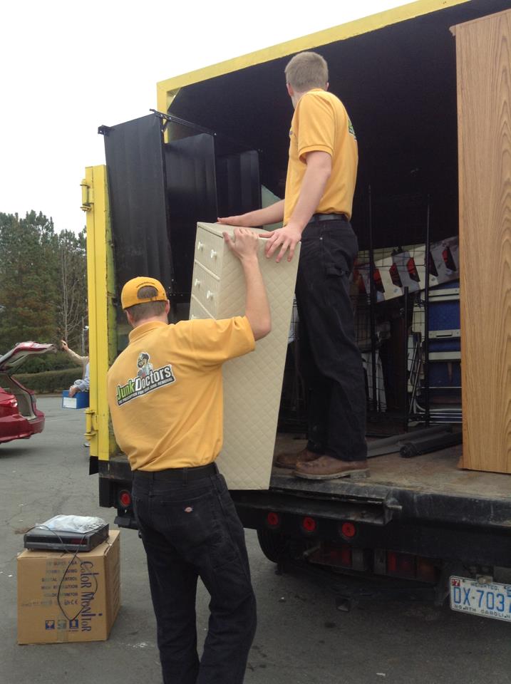 Junk removal professionals removing a file cabinet during office cleanout services