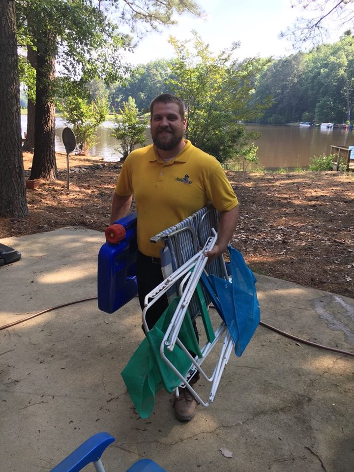 Junk Doctors professional carrying old ladders and junk off of a Reidsville property